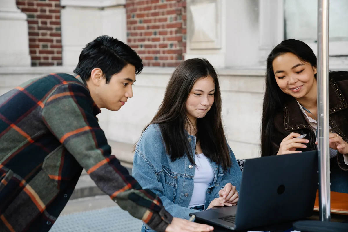 Adult learners studying together with a laptop